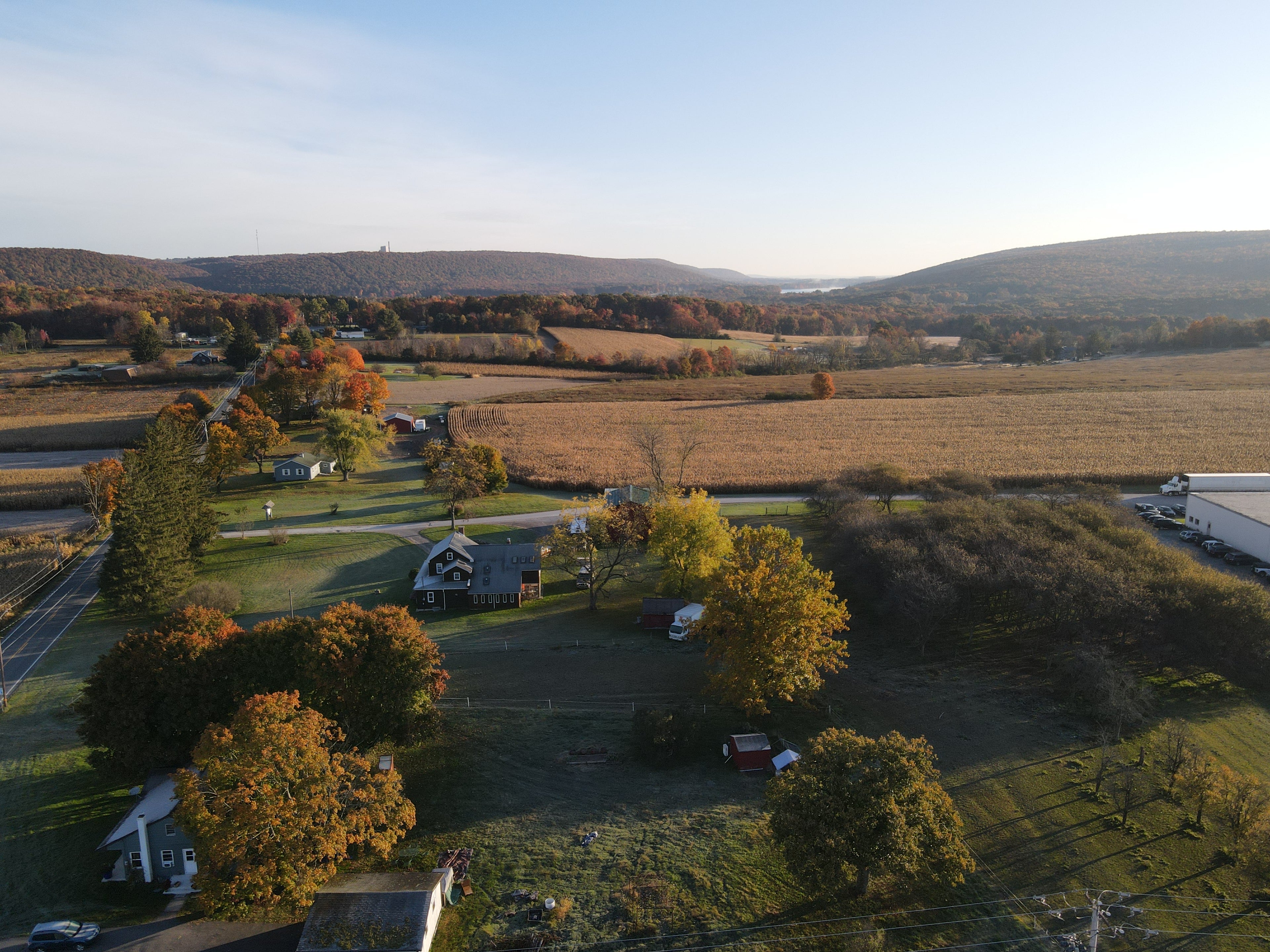 Mountains in background and farmhouse in front with farmland